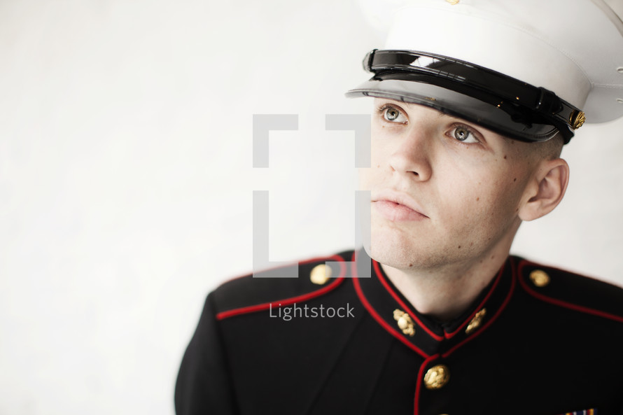 Marine in uniform looking up.
