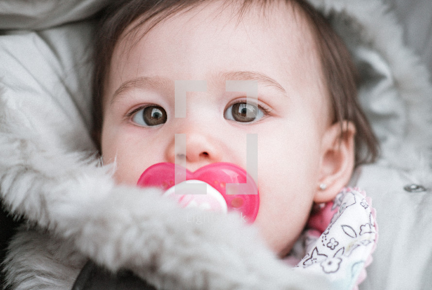 infant with a pacifier 