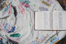 open Bible on a patchwork quilt 