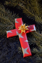 cross wrapped in paper as a present at Christmas day. 
presents, present, cross, Christmas, birth, death, born, die, dying, give, given, gave, son, advent, save, savior, saving, redeem, redeeming, redeemer, Christmas day, tree, fir, branch, twig, gift, star, stars, red, golden, wrap, wrapped, wrapping, wrap, packaging, packing, packed, pack, Xmas, fancy paper, gift wrap, wrapping paper