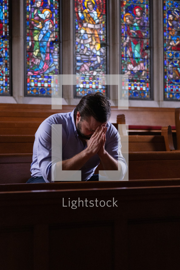 a man praying in a church 