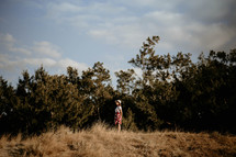 a woman standing in a field 