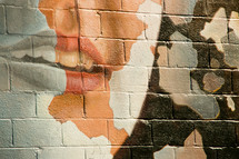lips painting on a brick wall 