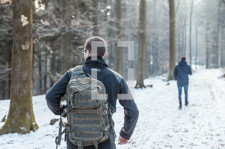 men hiking in the snow 