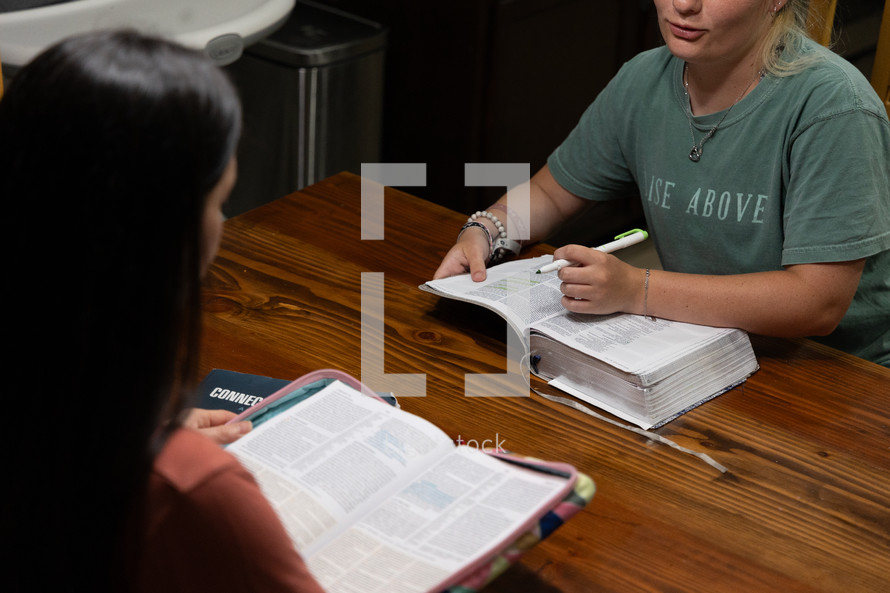 Two young women studying Bible during discipleship group Bible study