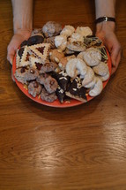 woman holding a plate of cookies 