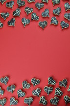 borders out of home made heart shaped cookies with chocolate on red background
