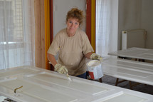 a woman painting a door 