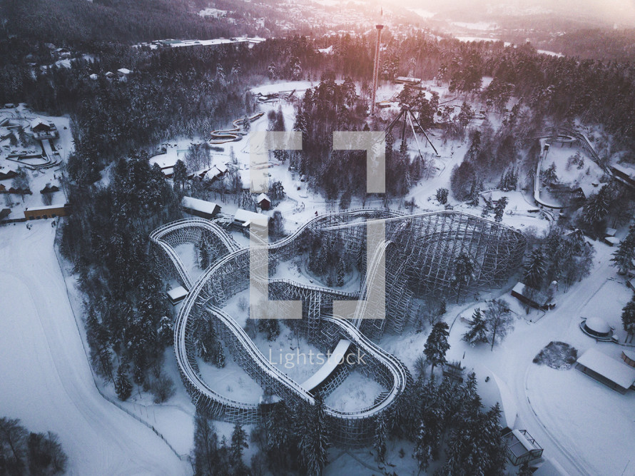 aerial view over a roller coaster in snow 