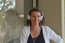 a woman listening to headphones 