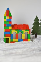 church made out of multicolored different wooden toy blocks as symbol for the community of believers
