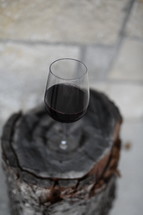 wine glass on a tree stump 