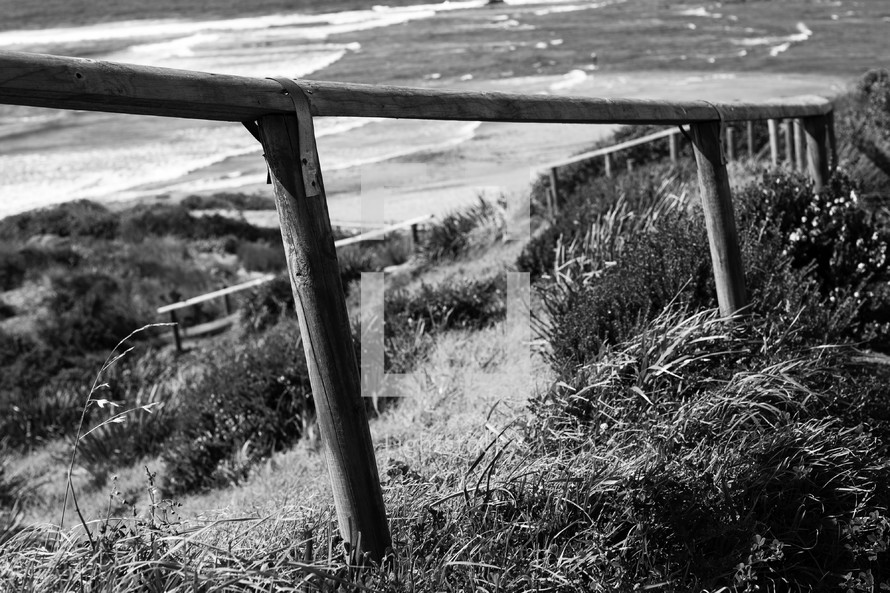 railing on sand dunes along a shore 