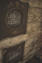 Unto us a child is born written on chalkboards