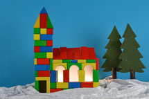 church built out of multicolored different wooden toy blocks as symbol for the community of believers