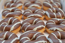 A tray of chocolate covered donuts.