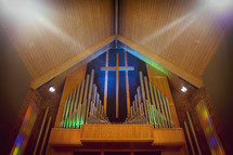 cross and organ pipes in a church