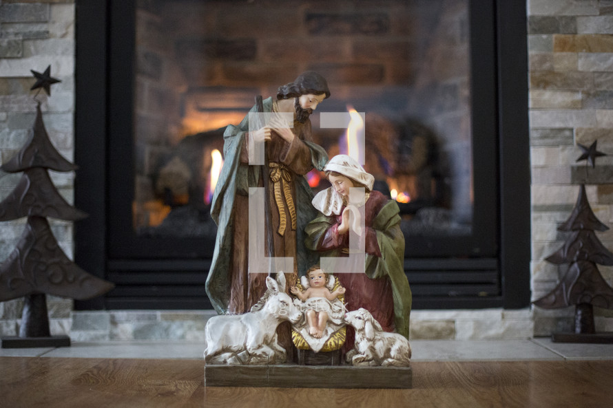 Nativity scene in front of a fireplace 