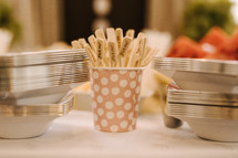 silver plates and toothpicks on a table at a reception 