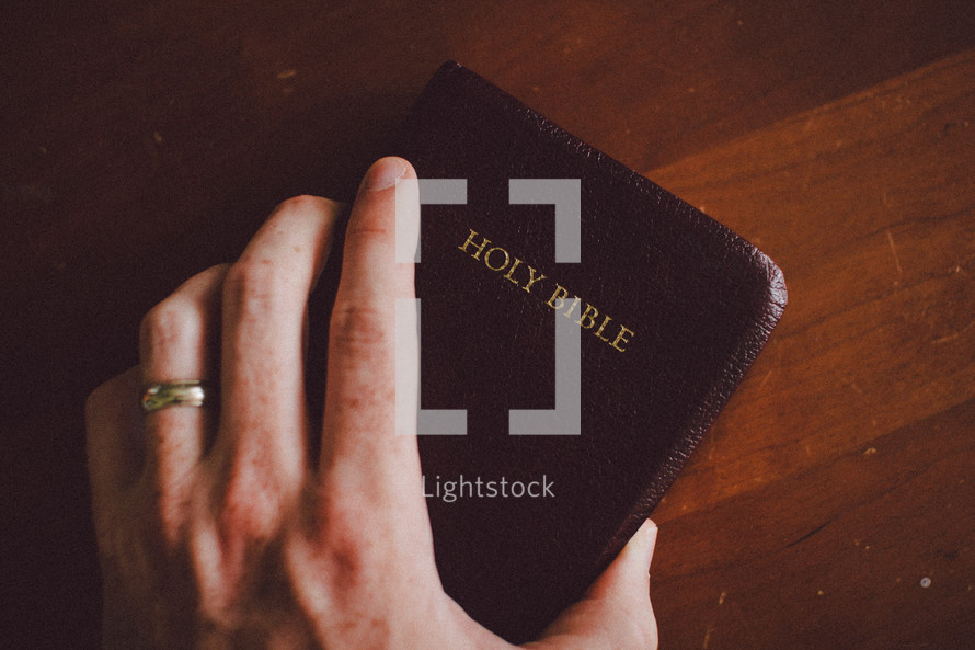 hand gripping a Bible 