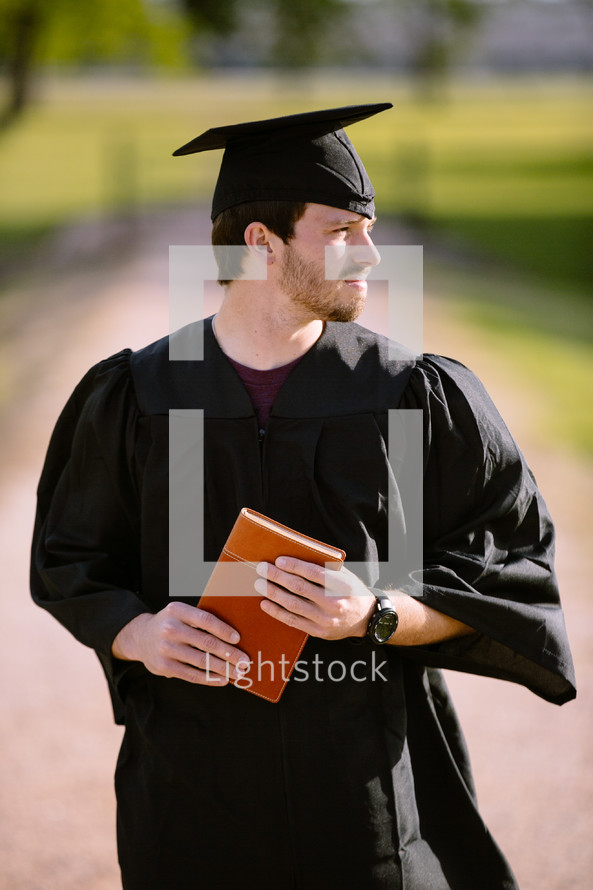 Graduate holding a Bible.