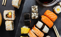Black slate tray of assorted sushi and rolls