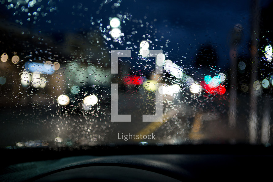 bokeh taillights through rainy windshield at night 