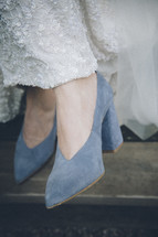 blue high heel shoes under a wedding gown 