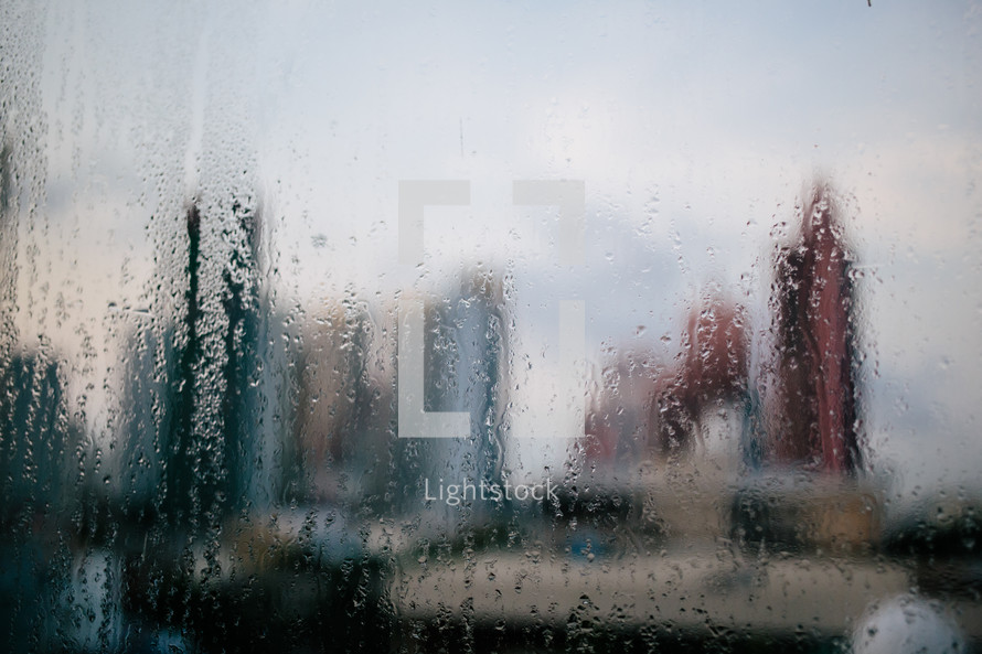 view of a city through a wet foggy blurred window 