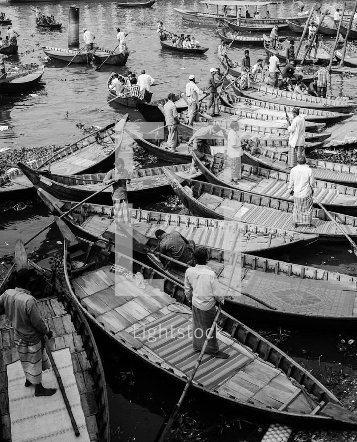 Boats with fishermen in Dhaka river in Bangladesh