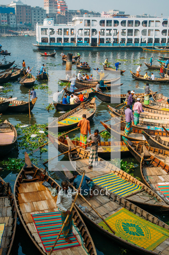 Boats with fishermen in Dhaka river in Bangladesh