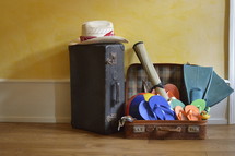 sun hat, and flip flops packed in a suitcase 