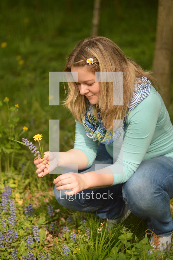 a woman picking flowers 
