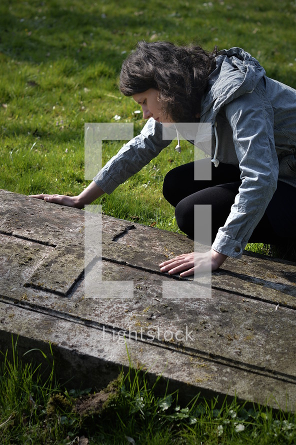 grieving woman at a gravesite 