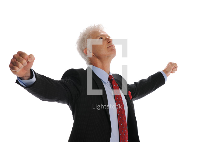 businessman holding his hands up in victory 