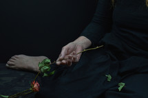 a woman with a bouquet of dead roses 