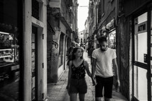 a couple walking hand in hand in Venice 