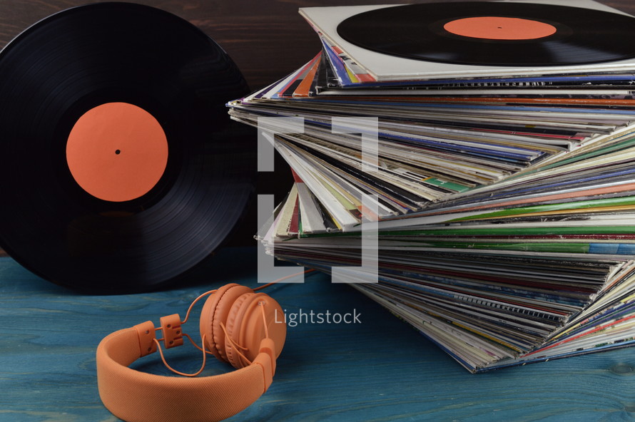 stack of vintage records and headphones 