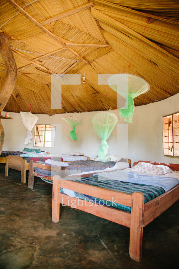 mosquito nets hanging over beds 