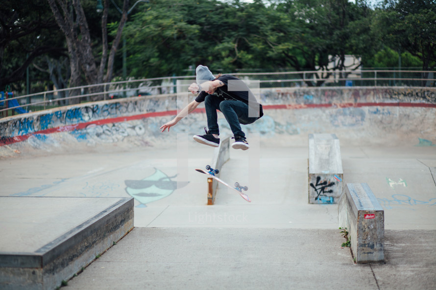 teen boy skateboarding in a skate park 
