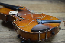 old broken violin on rural wooden floor
