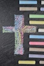 cross in sidewalk chalk on slate 