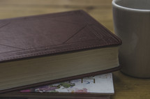 Bible, journal, and coffee mug on a table 