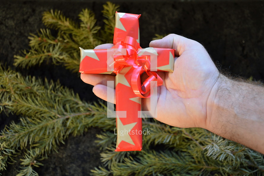 cross wrapped in paper as a present at Christmas day. 