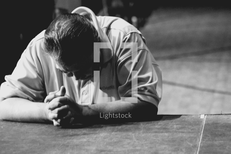 a man praying at the altar 