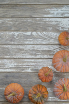 Musque de Provence pumpkins on raw gray wood boards 