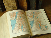 Old books with maps of Israel.