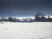 distant houses and footprints in snow 