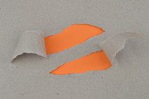ripped paper revealing orange blank space for words