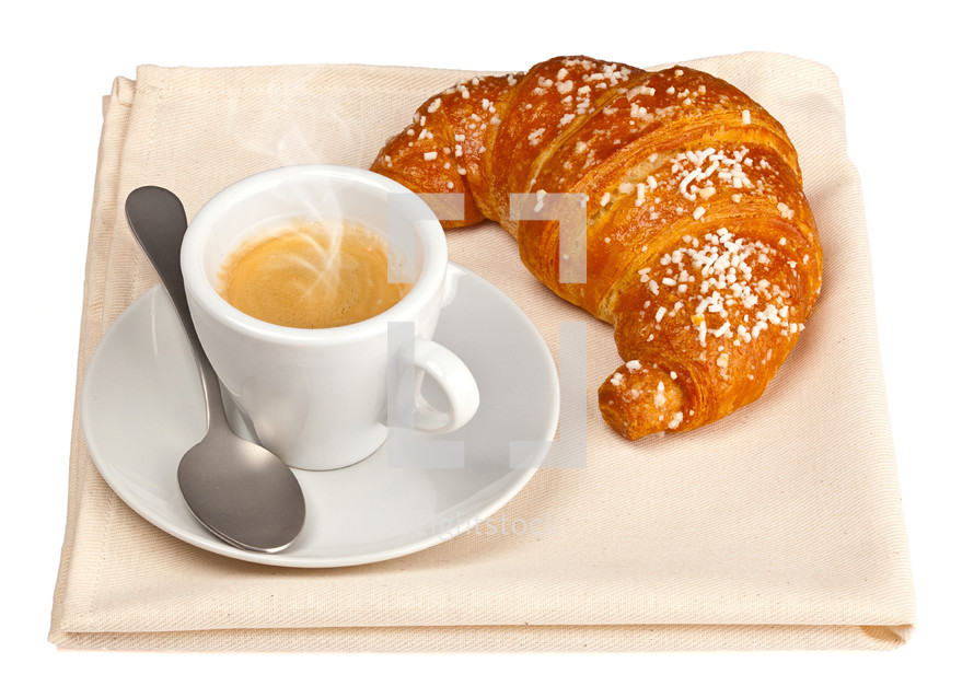 Espresso coffee with croissant on beige towel